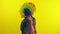 Little child girl clown in rainbow wig angry standing and waiting for something. Halloween