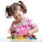 Little child girl playing with puzzle toys