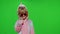 Little child girl smiling, dancing, showing thumbs up with hands in unicorn pajamas on chroma key