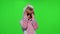 Little child girl smiling, dancing, winking, celebrating in unicorn pajamas costume on chroma key