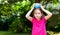 Little child, girl smiling playing with a water balloon outdoors, outside portrait, copy space. Kid holding a balloon filled with