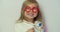 Little child girl wear red glasses holding stethoscope playing game as doctor, happy cute adorable small preschool kid