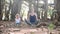 Little child girl with young mother meditating together under banyan tree