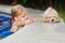 Little child with golden retriever puppy at poolside