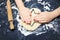 Little child hands with cookie cutter like a star making handmade traditional Christmas cookies. An overhead photo of kid`s hands,