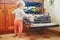 Little child helping to unload dishwasher