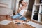 Little child kissing her mother on her chic while they are sitting on the floor