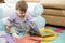 Little child looking at colorful book at home