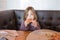 Little child looking at and eating pizza in restaurant