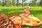 Little child in a park on green grass on a litter in a straw basket