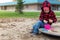 Little child playing outdoors at school yard. Kid at playgroung