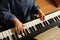 Little child playing piano, above view. Music lesson