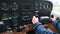 Little child playing pilot in the cabin of light sport aircraft, childhood dreams of flying, closeup of instrument panel