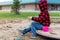 Little child playing with sand and toys outdoors at school yard