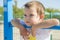 Little child is playing on the summer playground on the beach