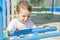 Little child is playing on the summer playground on the beach