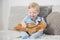 Little child plays doctor with teddy bear