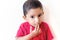 little child putting finger on mouth with small hairs