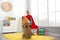 Little child in red cape playing with rocket made of cardboard box
