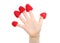 Little child\'s hand with raspberry hats on fingers