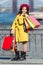 Little child shopping. Child stylish hold bunch shopping bags. Girl cute little lady coat and beret carry shopping bags