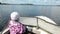 Little child standing near steering wheel in motorboat, Valday, Russia