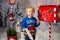 Little child, toddler boy, sending letter to santa in christmas mailbox, christmas decoration around him, outdoor snow shot