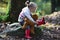 Little child tumn forest with teddy bear. Baby exploring nature on fall day.