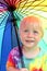 Little Child Under Rainbow Rain Umbrella