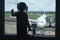 Little child waiting for boarding to flight in airport terminal