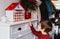 Little child waiting to open handmade advent calendar made from toilet paper rolls.