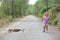 little child on the way surprised and laughing at horse droppings