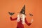 Little child in witch costume. Magical spell. Small witch with white hair. Wizard or magician. Halloween party. Photo