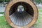 Little child in a wooden tunnel in a playground