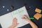 Little child writing letter to Santa Claus on a blank sheet of paper