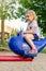 Little childplaying at playground in summer, sitting on carrousel