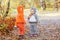 Little children in animal costumes playing in autumn forest