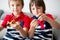 Little children, boy brothers, playing with colorful fidget spin