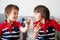 Little children, boy brothers, playing with colorful fidget spin