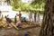 Little children playing outdoors in a background. A tree is in front in focus