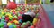 Little children playing in the pool with plastic balls in the nursery.