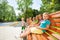 Little children rest on the bench in park