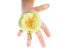 Little childs hand holding an unripe green apple