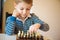 Little clever boy thinking with chess