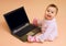 Little computer genius baby girl with laptop