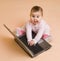 Little computer genius baby girl with laptop