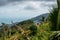 Little countryside house on tropical forest hills with a cloudy sky. Mountains and white clouds on a blue sky.