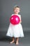 Little crying girl with pink balloon