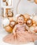 Little crying unhappy redhead baby girl celebrates first birthday anniversary. 1 year family party Professional