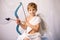 Little cupid toddle boy, holding bow and arrow, beautiful blond cherub